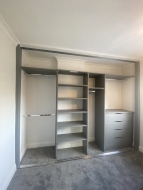 Onyx grey wardrobe interior with shallow shelving on a chimney breast, fitted in Marton